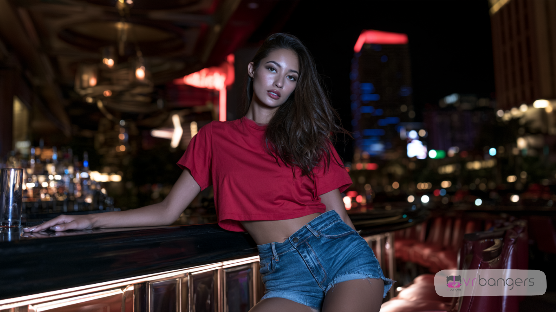 Femme adulte aux longs cheveux bruns, vêtue d’un crop top rouge et d’un short en jean, appuyée contre un bar dans une ambiance nocturne